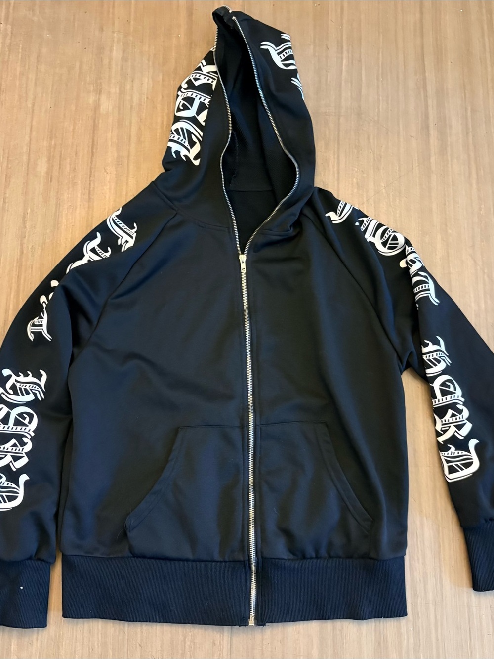 Black Zip-Up Hoodie with White Sleeve Graphics That Say Fight Hard
